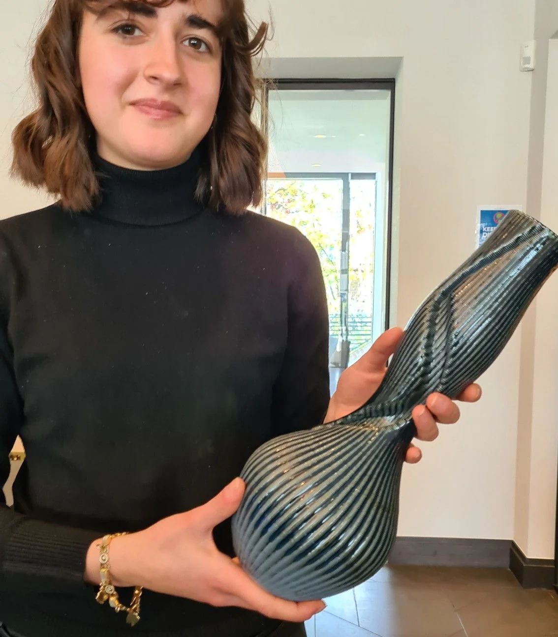 Completed kiln fired bespoke ceramic vase, with a sculpted twisting surface